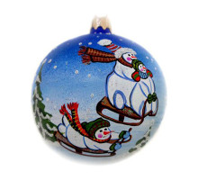 A blue handmade glass Christmas tree ball with an artistic painting, embellished with glitter "Snowmen with sledges", 3,25 inches