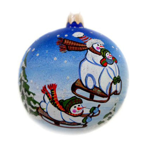 A blue handmade glass Christmas tree ball with an artistic painting, embellished with glitter "Snowmen with sledges", 3,25 inches