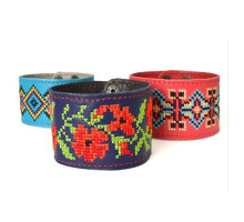 A wide men's leather bracelet embellished with a traditional Ukrainian embroidery