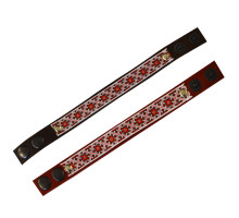 A leather bracelet with traditional Ukrainian red and black ornament