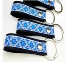 A leather keychain with a traditional sky-blue Ukrainian ornament