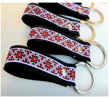A leather keychain with a traditional red Ukrainian ornament
