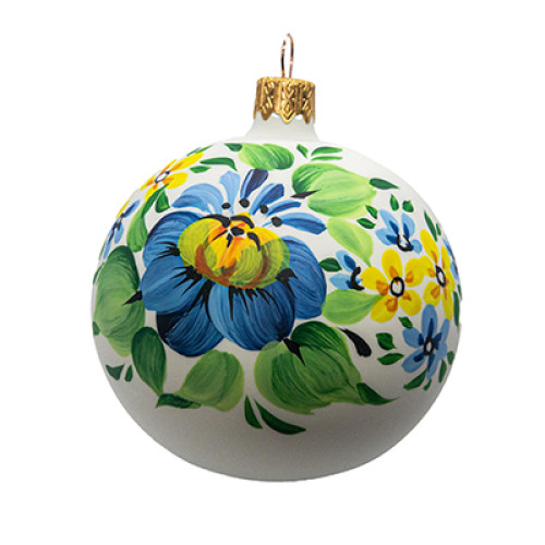 A white handmade glass Christmas tree ball with a blue and yellow flower painting, 3,25 inches