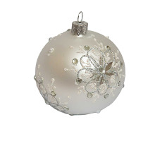 A silver handmade glass Christmas tree ball with a white depiction of a snowflake flower, embellished with beads and glitter, 3,25 inches
