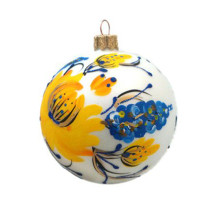 A white handmade glass Christmas tree ball with a depiction of yellow flowers, 4 inches