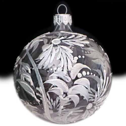 A transparent handmade glass Christmas tree ball with a white floral ornament, embellished with glitter, 3,25 inches