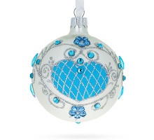 A white handmade glass Christmas tree ball embellished with voluminous sky-blue flowers, rhinestones and glitter, 3,25 inches