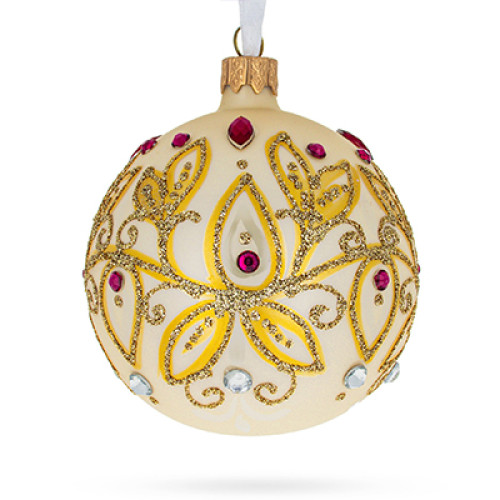 A champagne handmade glass Christmas tree ball with a golden floral ornament embellished with glitter and rhinestones, 3,25 inches