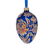 A blue handmade glass Christmas tree egg shaped pendant with a bright golden flower made in Petrykivskyi painting technique style, 2.6 inches