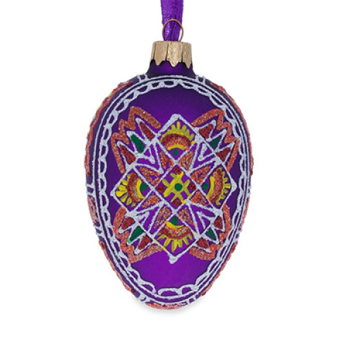 A purple handmade glass Christmas tree egg shaped pendant with a geometrical Ukrainian ornament, embellished with glitter, 2.6 inches