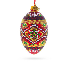 A red handmade glass Christmas tree egg shaped pendant with a Ukrainian traditional ornament, embellished with glitter, 2.6 inches