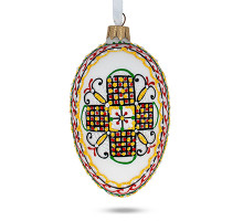 A white handmade glass Christmas tree egg shaped pendant with a Ukrainian traditional ornament, embellished with glitter, 2.6 inches