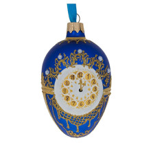 A blue handmade glass Christmas tree egg shaped pendant made in Faberge egg style with an artistic painting, embellished with glitter and beads, 2.6 inches