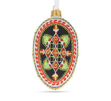 A green handmade glass Christmas tree egg shaped pendant with a geometrical Ukrainian ornament, embellished with glitter, 2.6 inches