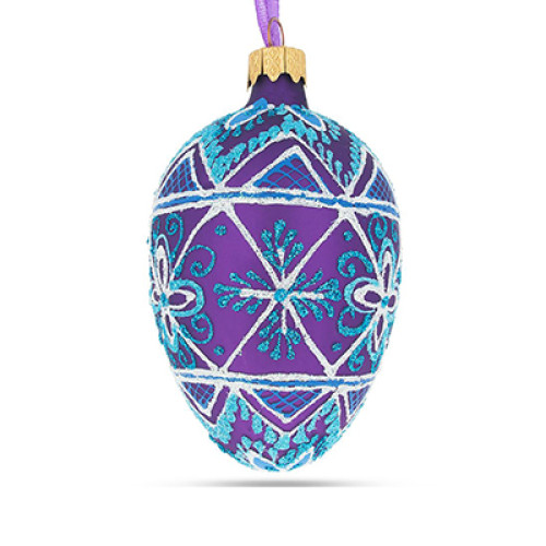 A purple handmade glass Christmas tree egg shaped pendant with a geometrical ornament, embellished with glitter, 2.6 inches