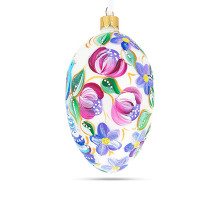 A white handmade glass Christmas tree egg shaped pendant with a Ukrainian traditional ornament, embellished with glitter "A blue bird", 2.6 inches