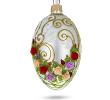A silver handmade glass Christmas tree egg shaped pendant with a floral ornament, embellished with 3D flowers and glitter, 2.6 inches