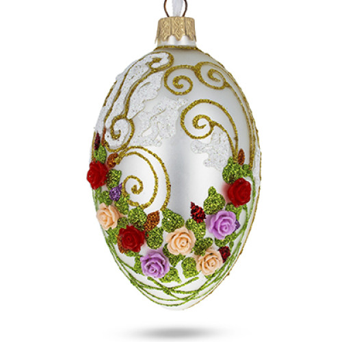 A silver handmade glass Christmas tree egg shaped pendant with a floral ornament, embellished with 3D flowers and glitter, 2.6 inches