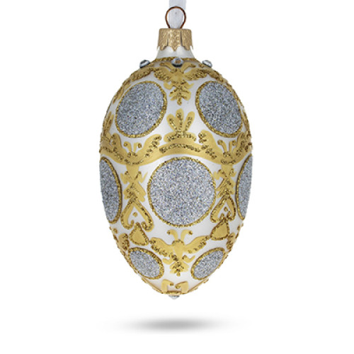 A silver handmade glass Christmas tree egg shaped pendant made in Faberge egg style with an artistic painting, embellished with glitter and rhinestones, 2.6 inches