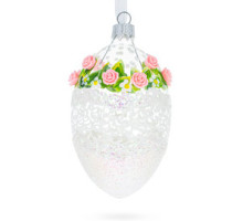 A transparent handmade glass Christmas tree egg shaped pendant with a lacy ornament, embellished with 3D roses and glitter, 2.6 inches
