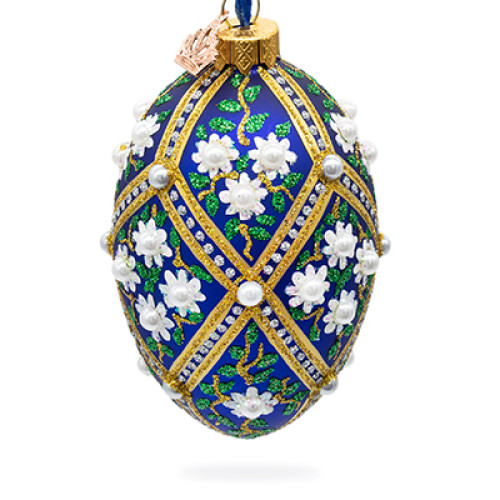 A blue handmade glass Christmas tree egg shaped pendant with a traditional ornament, embellished with glitter and pearls "White flowers", 2.6 inches