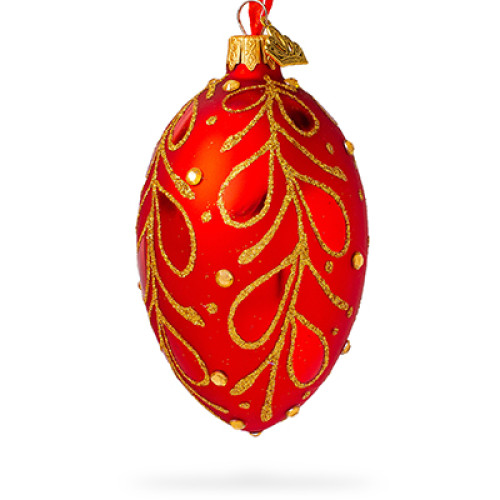 A red handmade glass Christmas tree egg shaped pendant with a gentle golden floral ornament, embellished with glitter and pearls, 2.6 inches