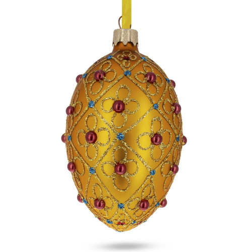 A golden handmade glass Christmas tree egg shaped pendant with a traditional tracery, embellished with glitter and rhinestones, 2.6 inches