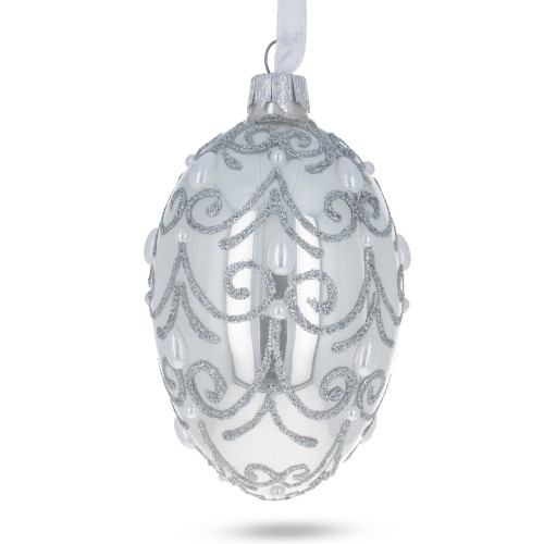 A specular handmade glass Christmas tree egg shaped pendant embellished with glitter and pearls, 2.6 inches