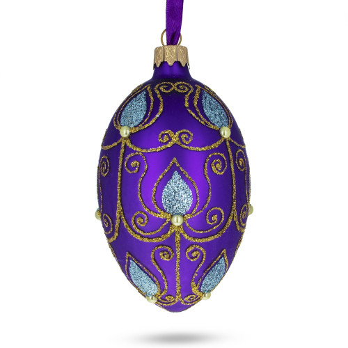 A purple handmade glass Christmas tree egg shaped pendant with sky blue leaves and a gentle ornament, embellished with glitter, pearls and 3D flowers, 2.6 inches