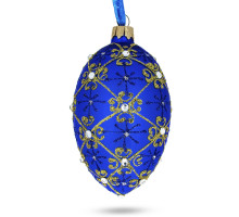 A blue handmade glass Christmas tree egg shaped pendant with a traditional ornament, embellished with glitter and precious stones, 2.6 inches