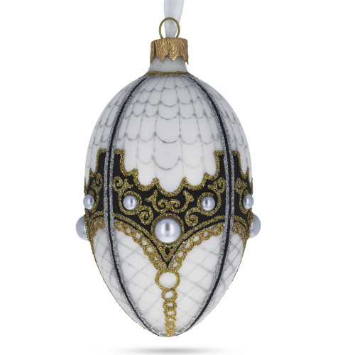A white handmade glass Christmas tree egg shaped pendant with a traditional ornament, embellished with glitter and pearls, 2.6 inches